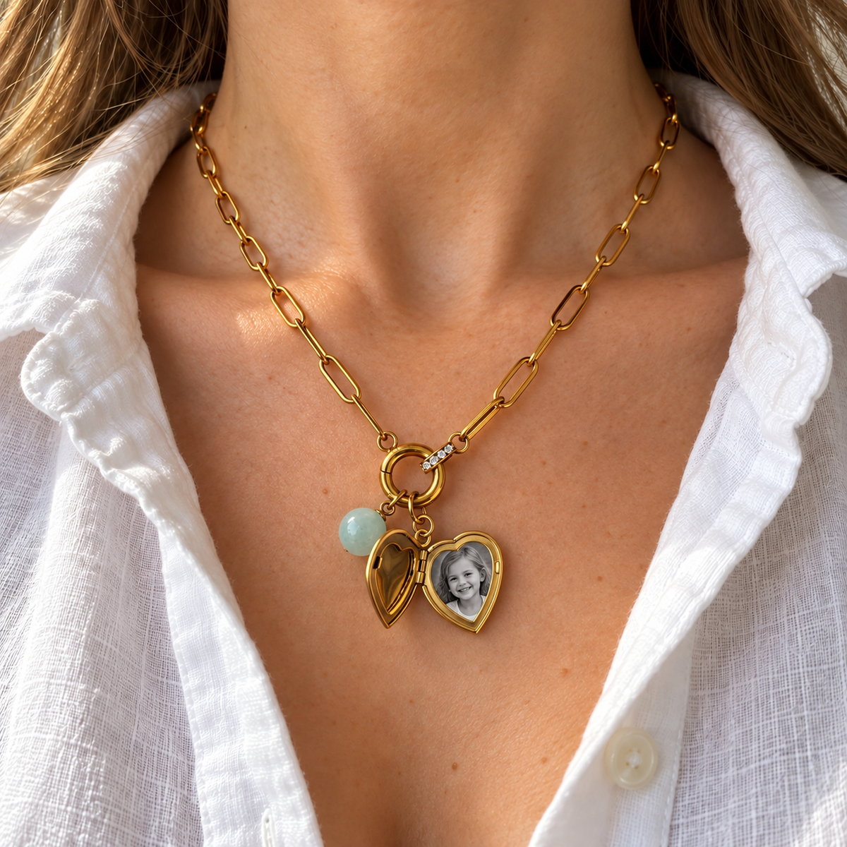 Heart locket shown open with illustrative photograph