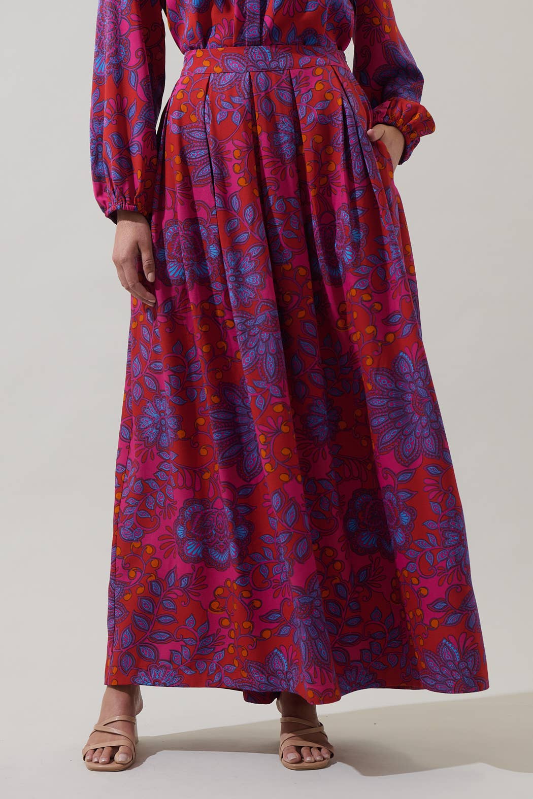 Sugarlips Darret Floral Lucie Pleated Maxi Skirt in fuchsia with colorful floral pattern, flowing pleated design, and lightweight fabric.