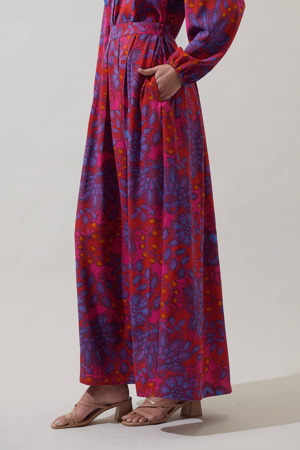 Sugarlips Darret Floral Lucie pleated maxi skirt in vibrant fuchsia with colorful floral pattern and flowing silhouette.