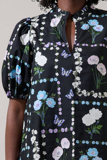 Sugarlips Trevis Noir Garden Blouse, stylish black top with floral pattern, featuring a flowy fabric and elegant neckline.