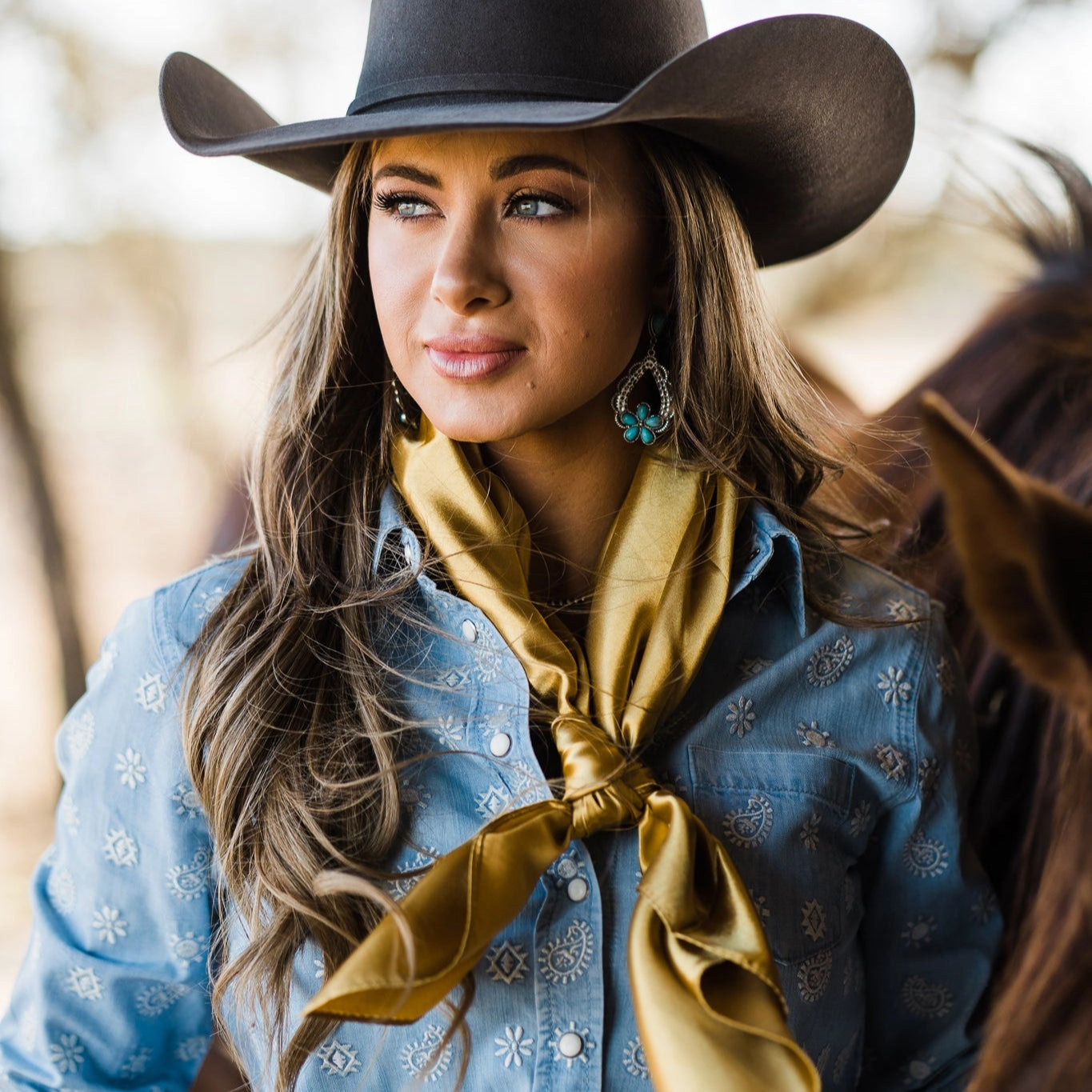 The Goldenrod Square Scarf worn at the neck