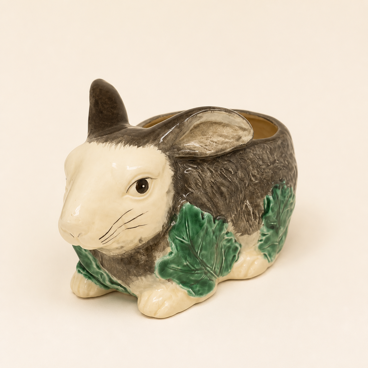 Figural majolica-style bunny planter on an ivory studio background