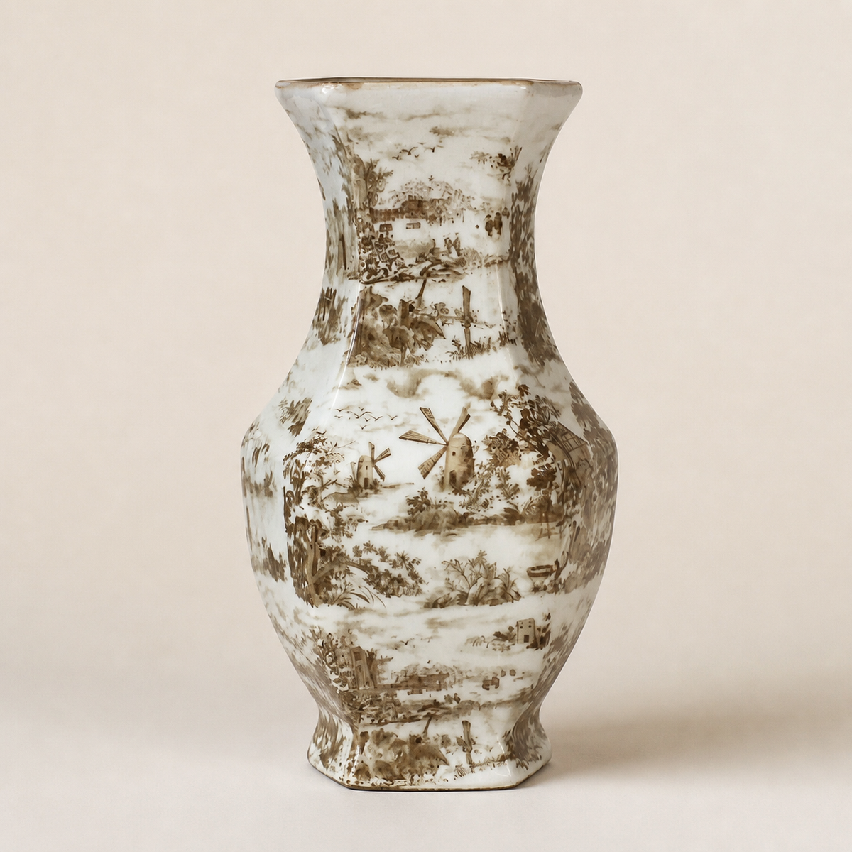 Hexagonal sepia transferware baluster vase on an ivory studio background