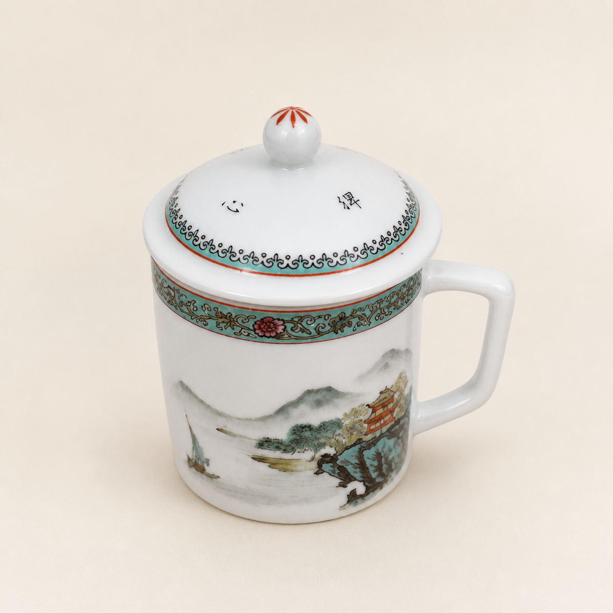 Jingdezhen landscape lidded tea mug on an ivory studio background