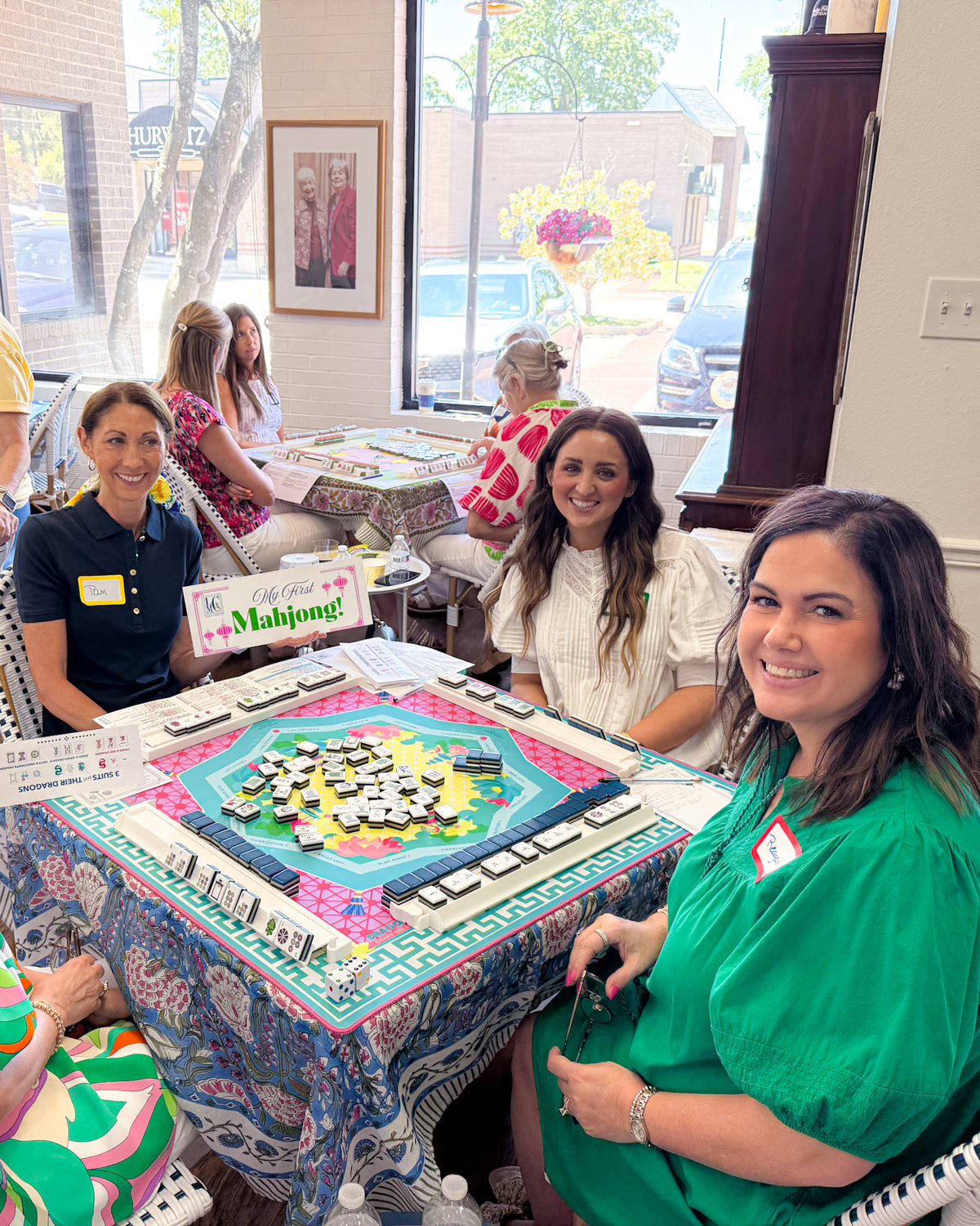 Friends gathered around a colorful Mahjong table at Alice & Elizabeth
