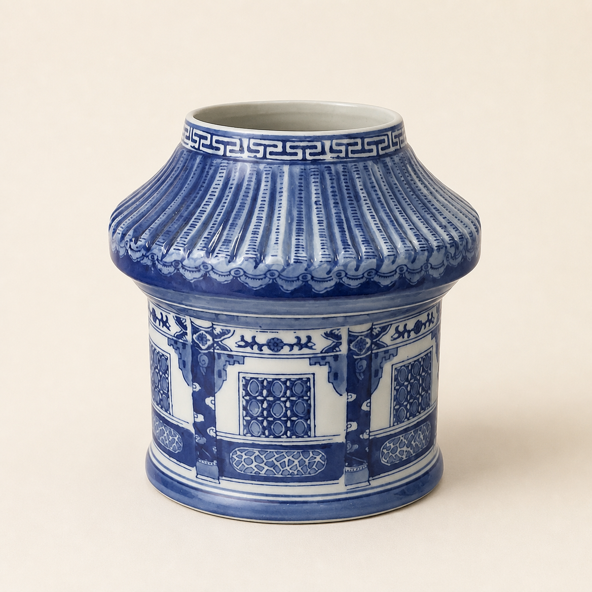 Pagoda-form blue and white vase on an ivory studio background
