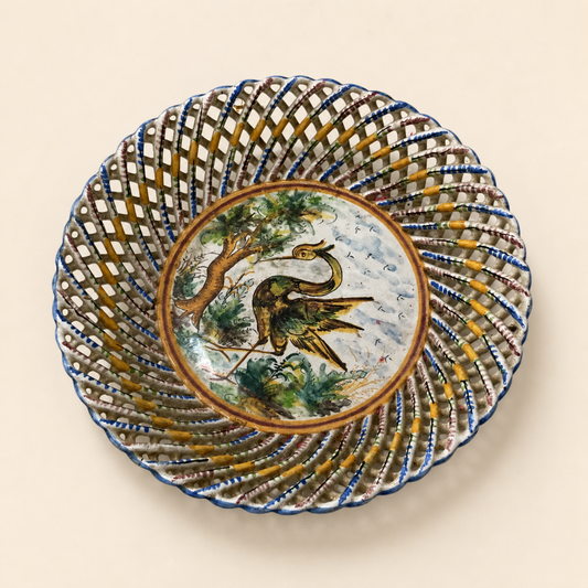 Spanish reticulated Talavera-style heron plate on an ivory studio background