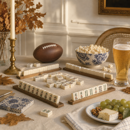 Mahjong tiles, a leather football, beer, and elegant tailgate snacks in warm autumn light