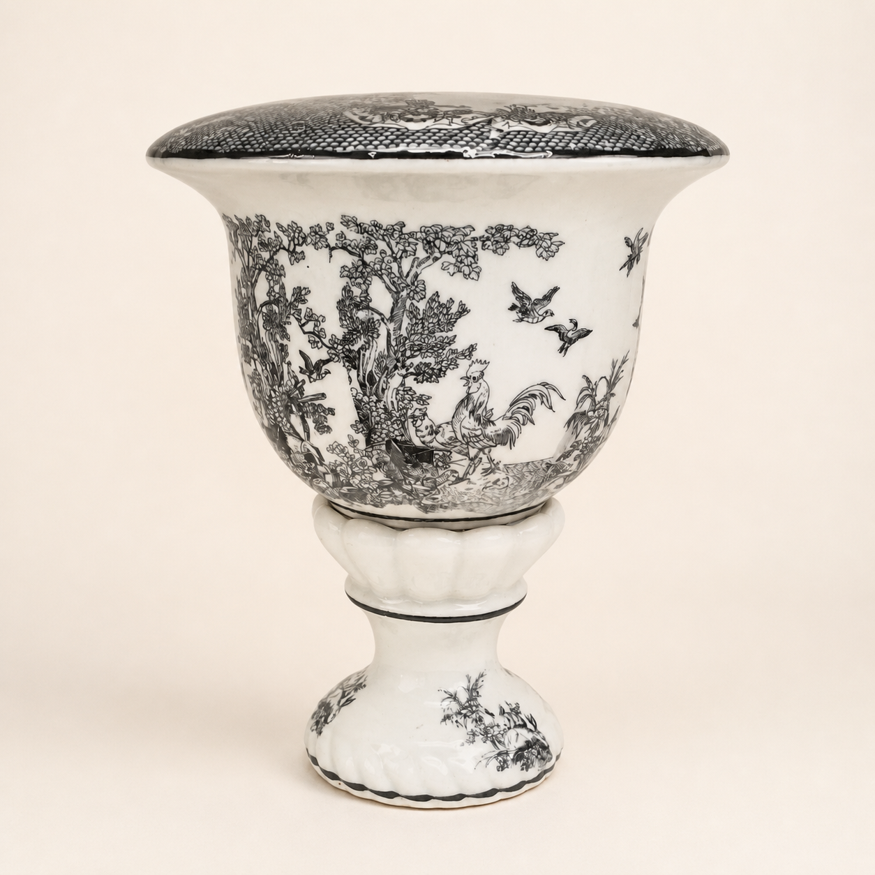 Black-and-white toile rooster pedestal urn on an ivory studio background