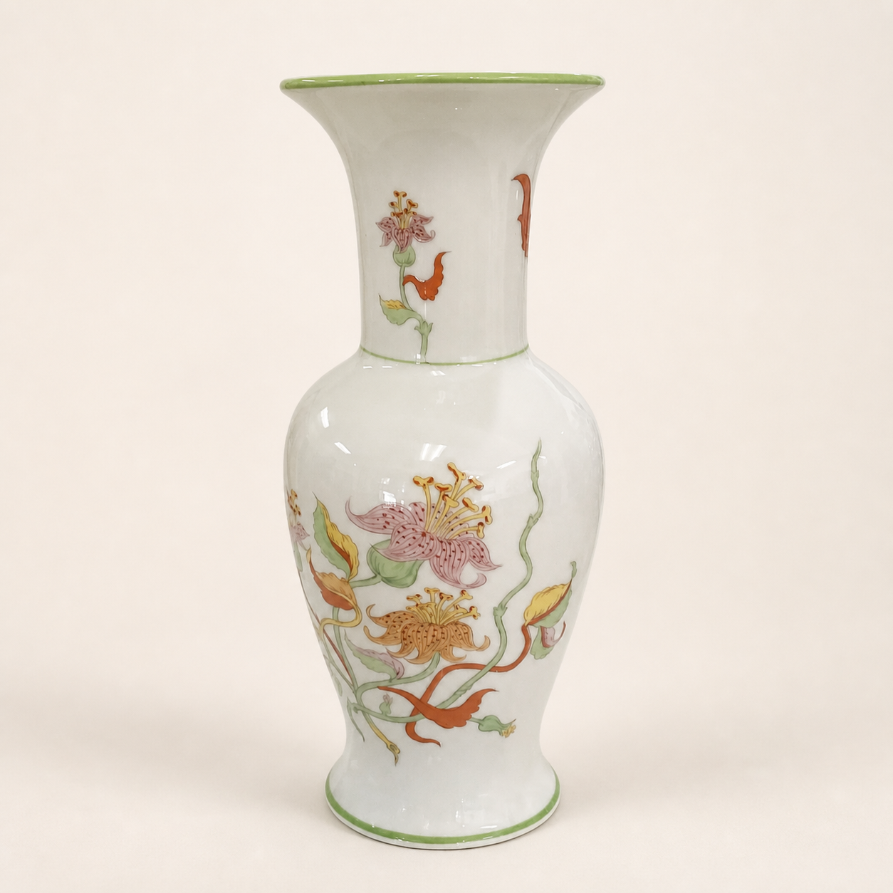 Japanese floral lily and vine vase with green rim on an ivory studio background